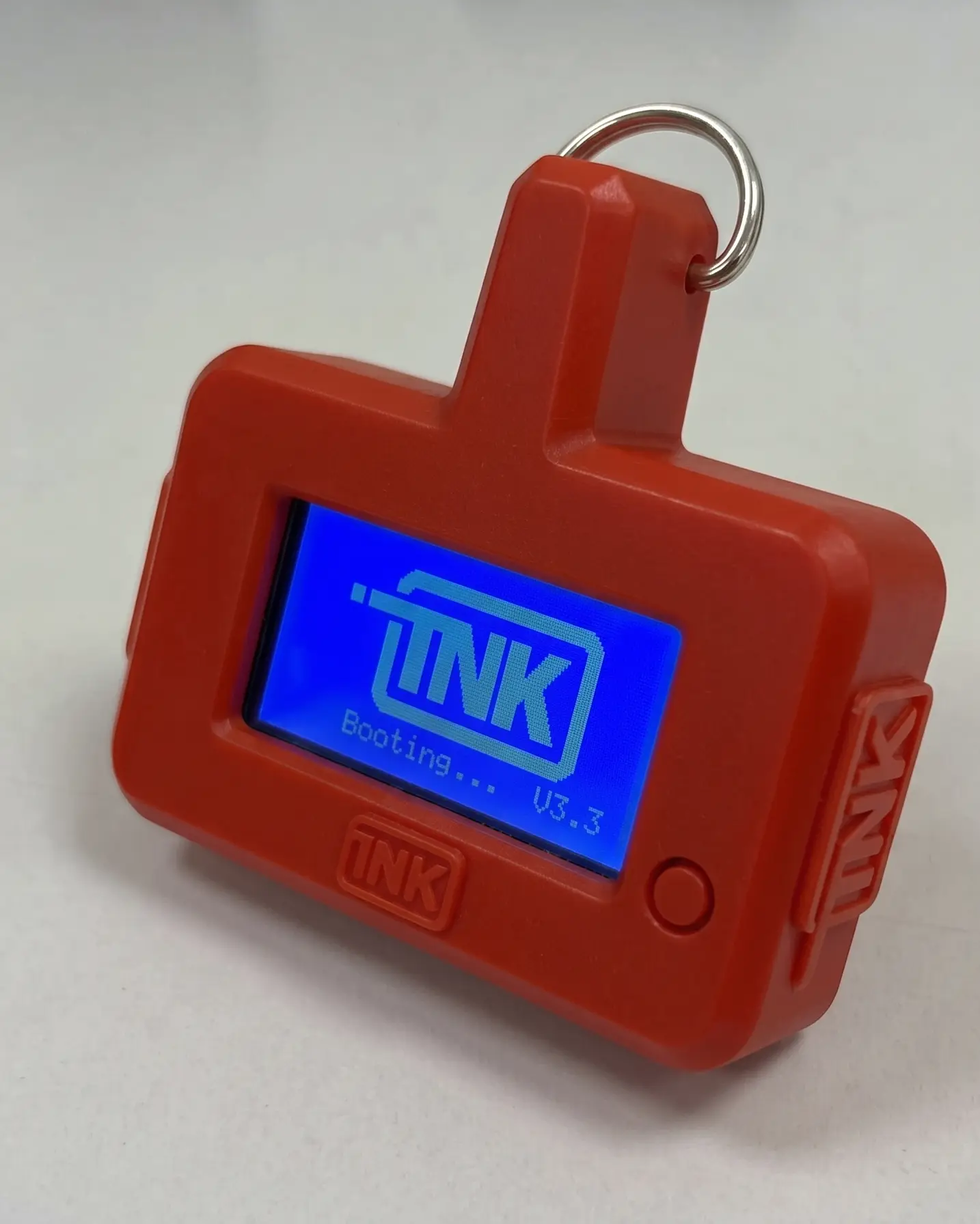 CarDefense Mobile handheld detector from the front, with a red case and its screen on