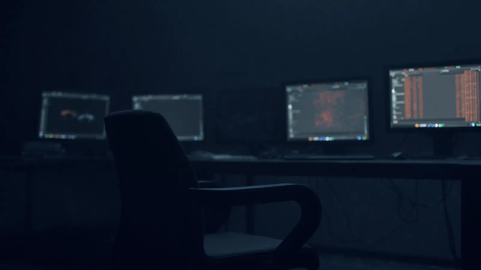 An empty monitoring room with the screens on